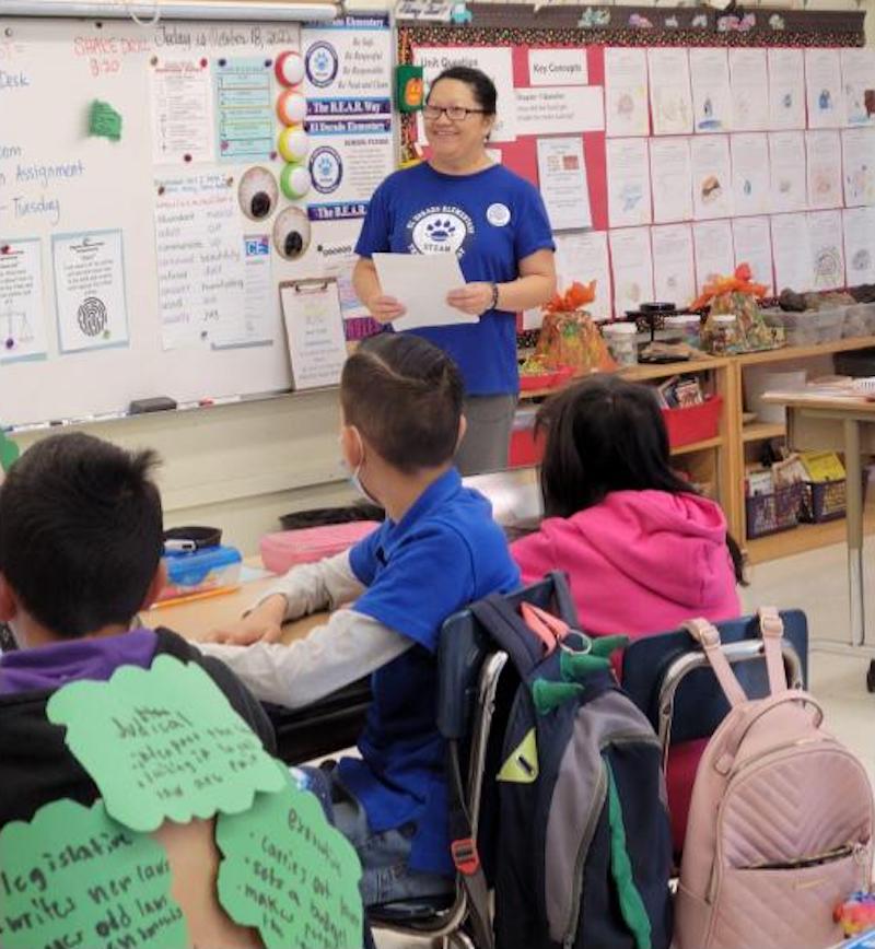 Ms. Ly working with her students